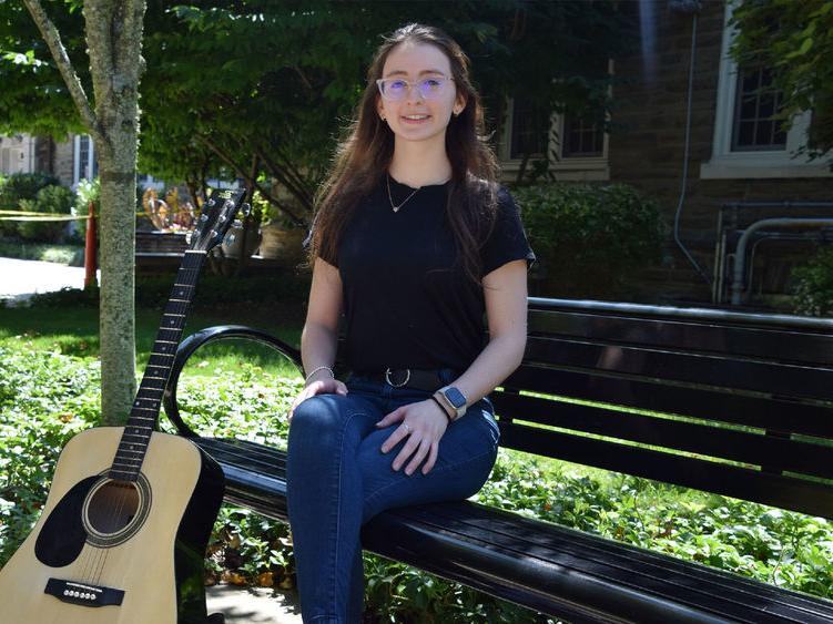 Penn State Abington graduate Vanessa Sexton posing with guitar